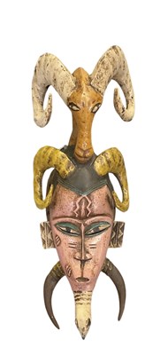 Lot 1130 - An African Guro pink, yellow and green painted...