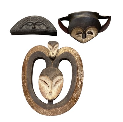 Lot 1047 - Two carved wooden Kwele masks, the larger 45 x...