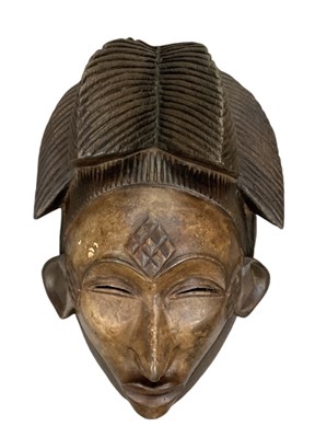 Lot 1120 - An African carved wooden Punu mask, height 36cm.
