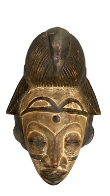 Lot 1122 - An African carved wooden Punu mask, height 35cm.