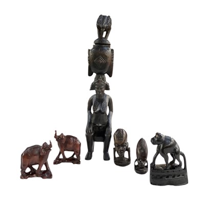 Lot 1044 - An African carved wooden Senufo pot, modelled...