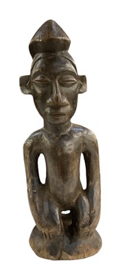 Lot 1118 - An African carved wooden figure in the style...