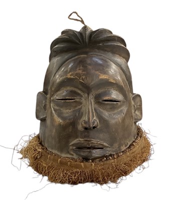 Lot 1116 - An African carved wooden Suku helmet hanging...