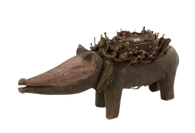 Lot 1021 - A carved wooden Korzo nail fetish dog, with...