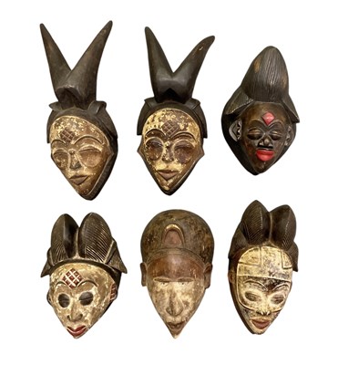 Lot 1022 - Six African carved wooden Punu masks,...