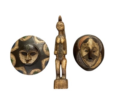 Lot 1068 - Two African carved wooden hand painted masks,...