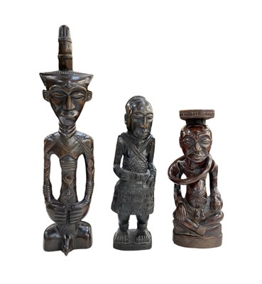 Lot 1024 - Three African carved wooden figures including...