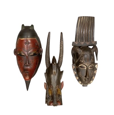 Lot 1082 - Three African carved wooden masks including...