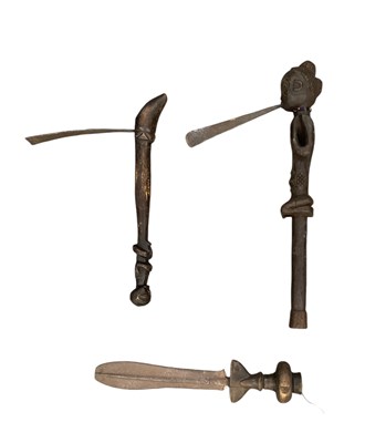 Lot 1083 - Two African carved wooden figural axes,...