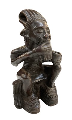 Lot 1081 - An African carved wooden Baule seated figure,...