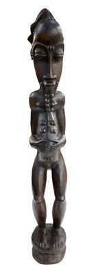 Lot 1095 - A tall African carved wooden Baule figure,...