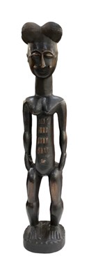 Lot 1097 - A tall African carved wooden Guro/Baule figure,...