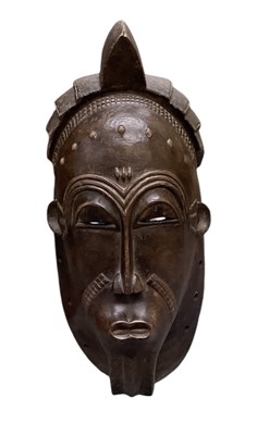 Lot 1103 - An African carved wooden Baule mask, height...