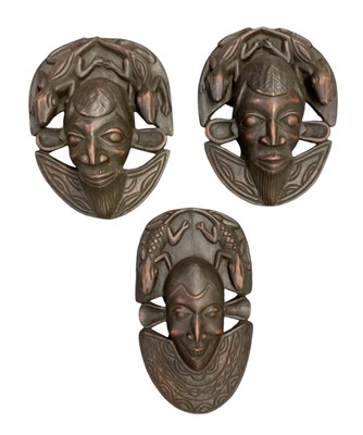 Lot 1084 - Three African carved wooden masks, all...