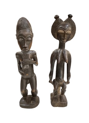 Lot 1074 - A pair of African carved wooden male and...