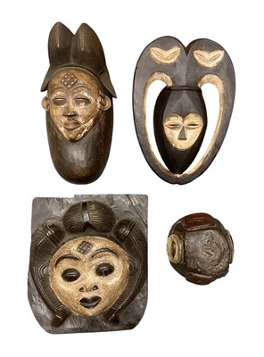 Lot 1036 - An African carved wooden double faced helmet...