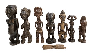 Lot 1034 - Seven African carved wooden figures, height of...
