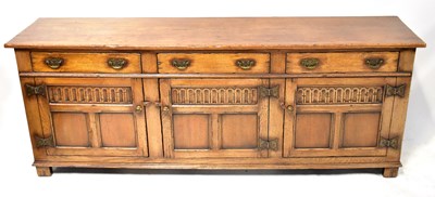 Lot 100 - A reproduction oak dresser base, possibly...
