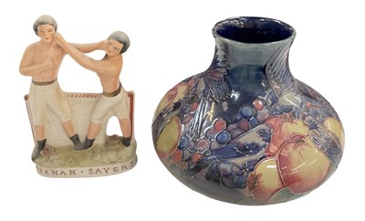 Lot 539 - MOORCROFT; a blue ground art pottery vase with...