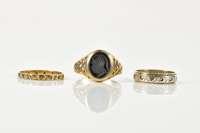 Lot 1473 - A 9ct yellow gold signet ring, size S, and two...