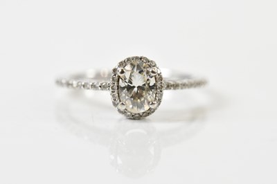 Lot 1290 - A 14ct white gold diamond ring, the four claw...