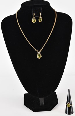 Lot 1364 - A suite of peridot and diamond set jewellery...