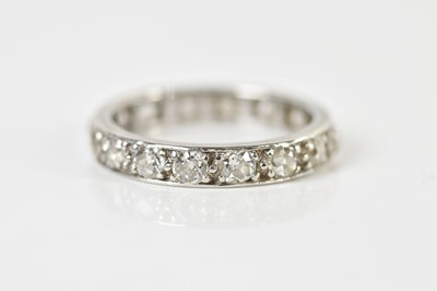 Lot 1346 - A white metal diamond full eternity ring, size...