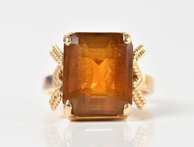 Lot 1452 - A yellow metal dress ring with emerald cut...