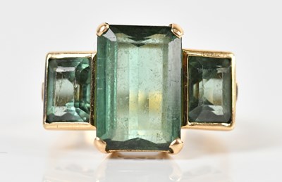 Lot 1314 - A yellow metal three stone ring, each emerald...