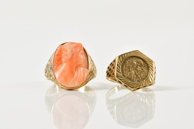 Lot 1479 - A yellow metal carved coral ring, size K,...