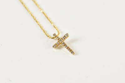 Lot 387 - An 18ct yellow gold chain suspending a small...