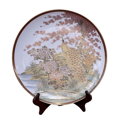 Lot 1195 - A Japanese Satsuma shallow dish, painted with...