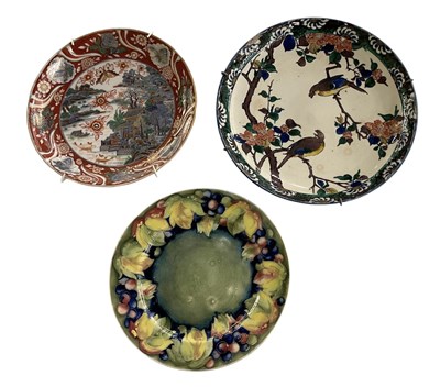 Lot 552 - MOORCROFT; a green glazed floral decorated art...