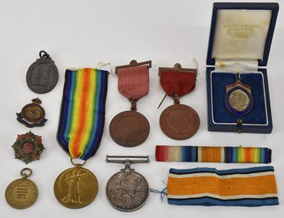 Lot 430 - A group of medals and badges including...