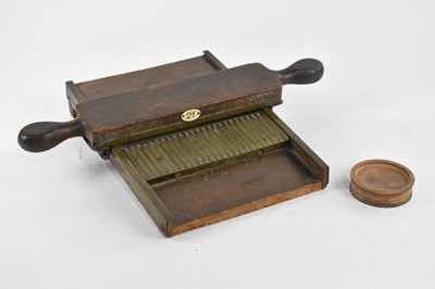 Lot 2540 - A 19th century mahogany pill maker, length 30cm.
