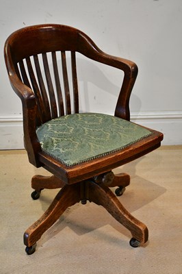 Lot 2376 - A 1920s oak office chair with green...