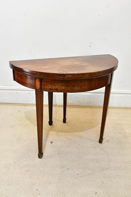 Lot 2377 - A Georgian inlaid mahogany demi-lune fold-over...