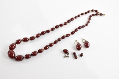 Lot 1625 - A cherry amber beaded necklace with three...