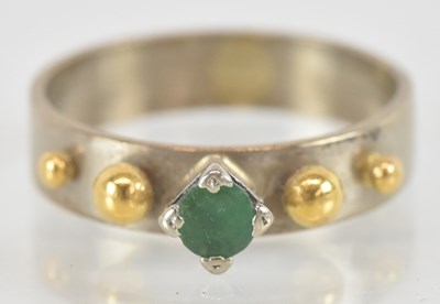 Lot 1403 - An 18ct white and yellow gold emerald set ring,...