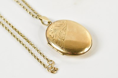 Lot 1643 - A 9ct yellow gold oval locket with engraved...