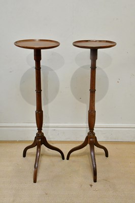Lot 2452 - A pair of mahogany torchere stands, height 117cm.