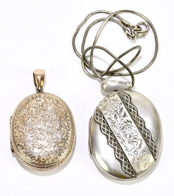 Lot 1404 - An oval silver locket on chain, and a yellow...