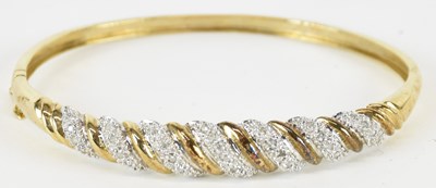 Lot 1397 - A 9ct gold hinged bracelet, the front with...