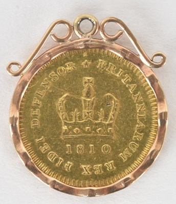 Lot 1594 - A George III 1810 1/3 gold guinea, in claw set...