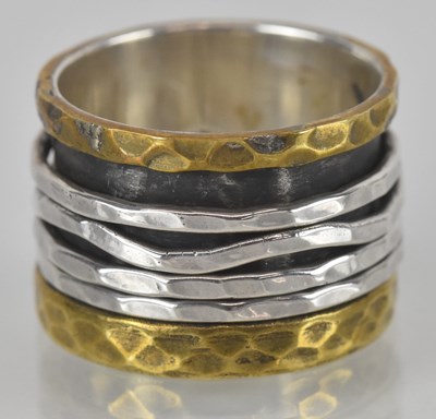 Lot 1543 - A silver (925) contemporary ring, the wide...