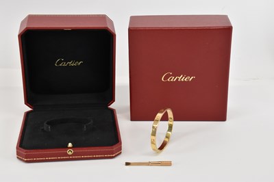 Lot 1352 - CARTIER; an 18ct gold hinged LOVE bracelet...