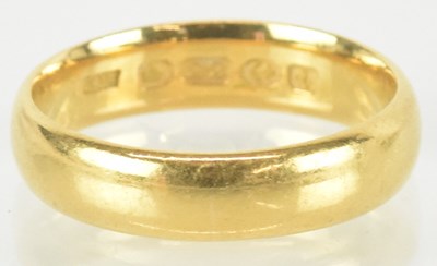 Lot 1384 - A 22ct gold band ring, size R, approx 7.1g.