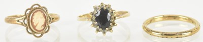 Lot 1462 - Three 9ct gold rings comprising a band ring,...