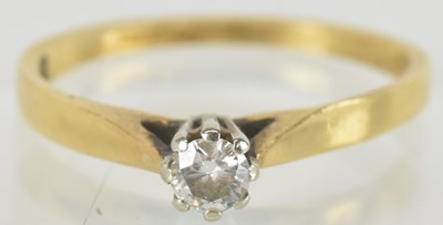 Lot 1435 - An 18ct gold diamond solitaire ring, the...