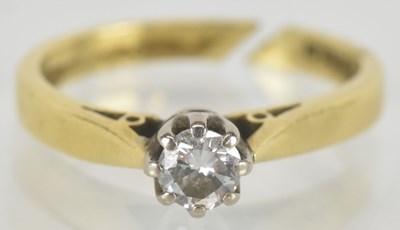 Lot 1466 - An 18ct gold diamond solitaire ring with a cut...